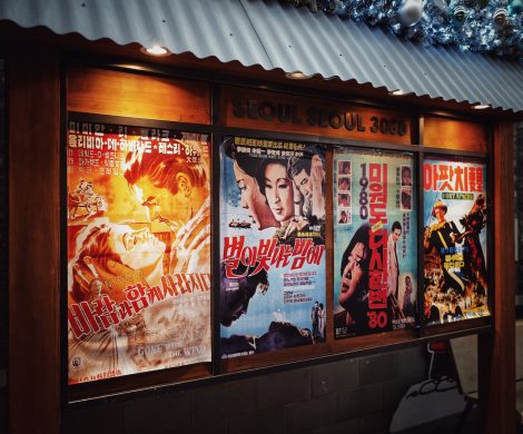 four movie posters on wall