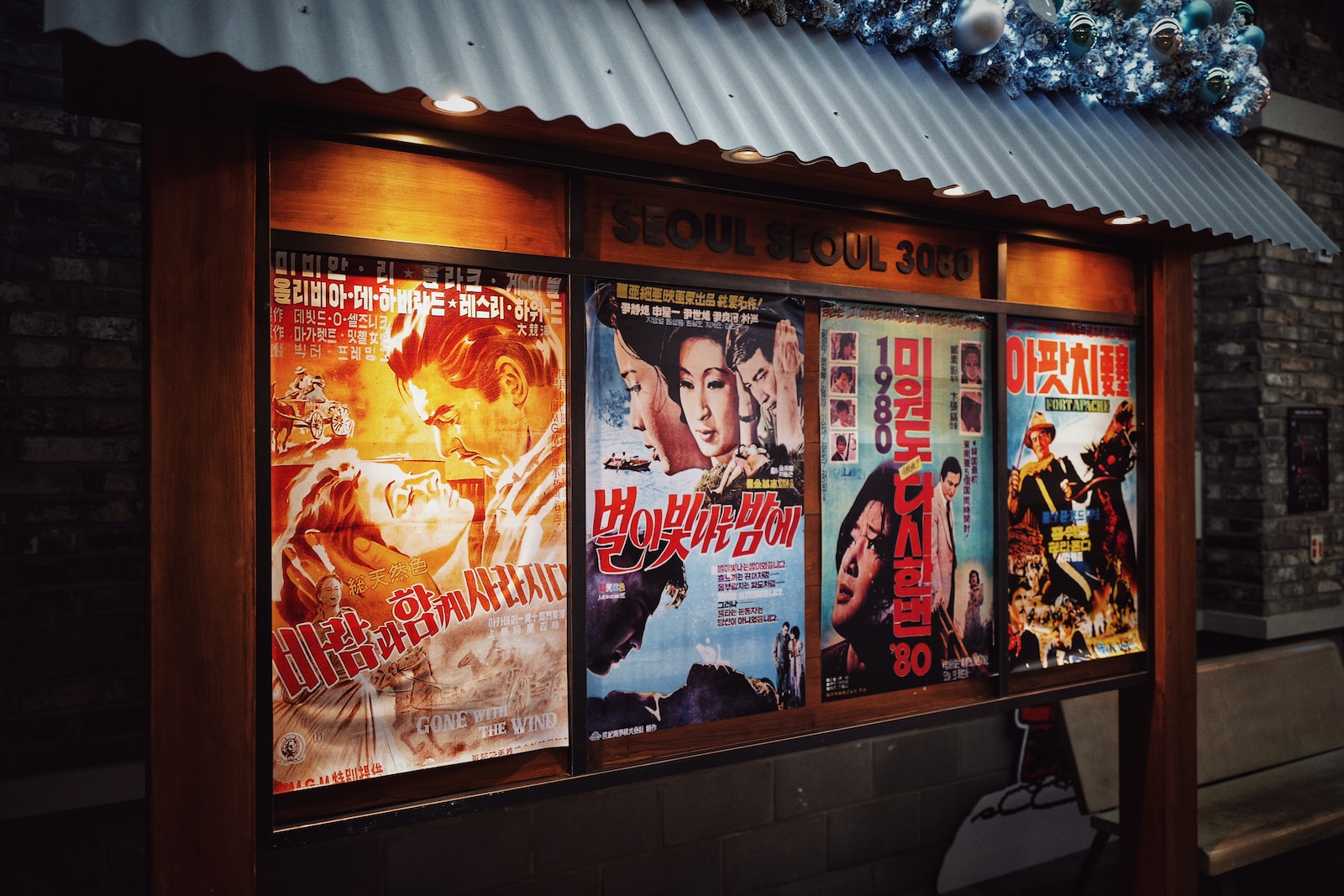 four movie posters on wall