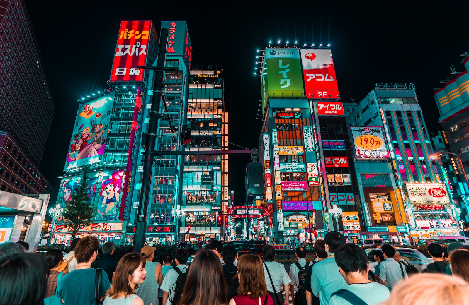 group of people watching lighted clear, red, and green high-rise building