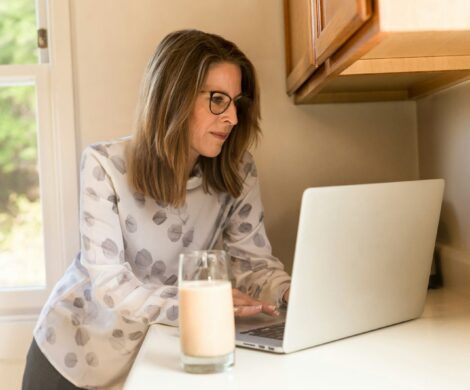 woman using her MacBook Pro inside white room